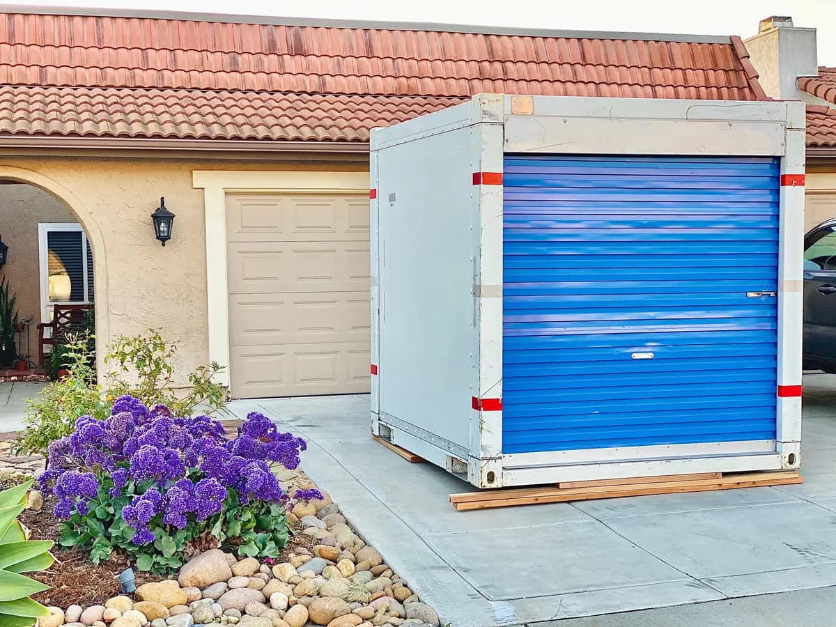 A portable storage container on a suburban driveway