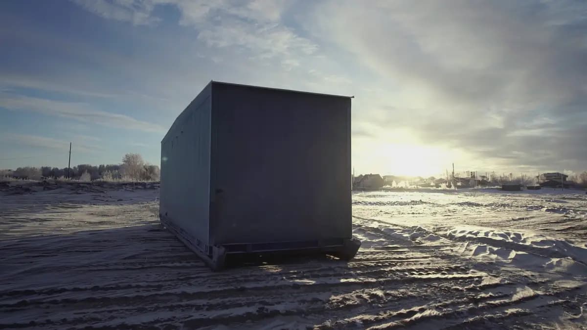 A shipping container in a snowy field