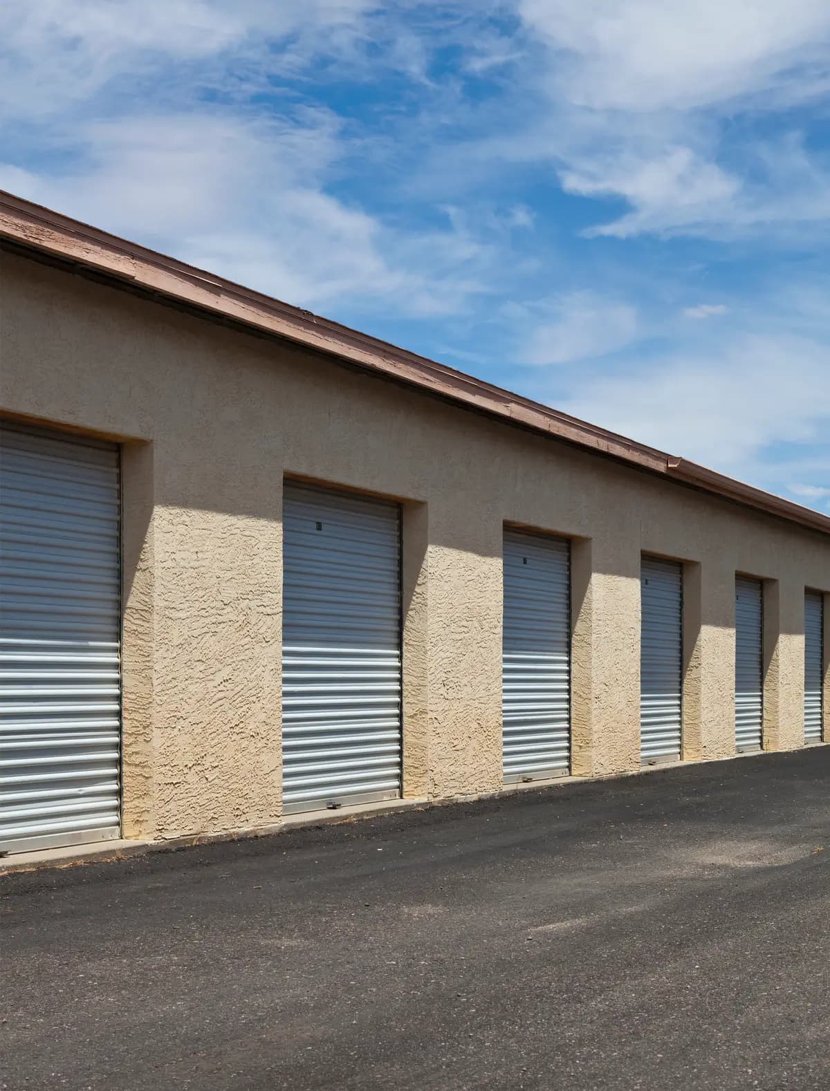 The facade of a self storage building on a sunny day