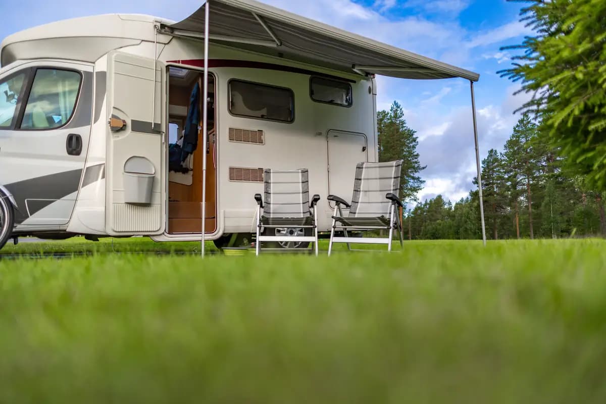A recreational vehicle parked on grass